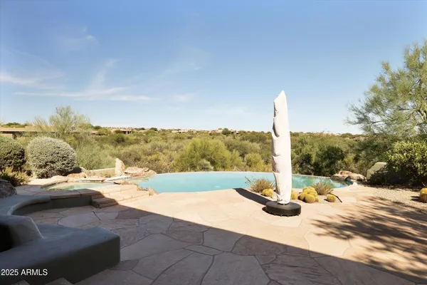 a view of a swimming pool with a yard