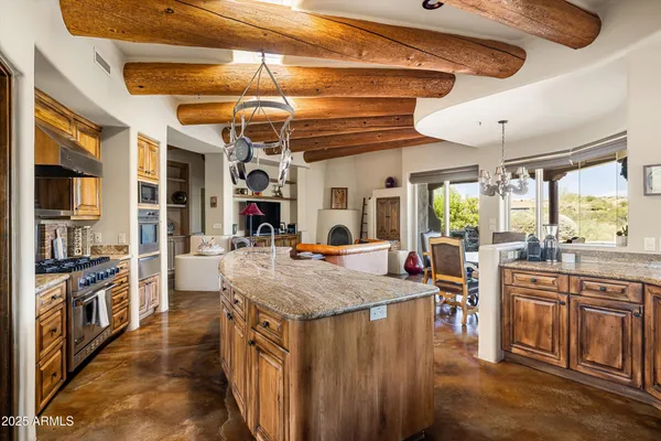 a kitchen with stainless steel appliances granite countertop a stove and cabinets
