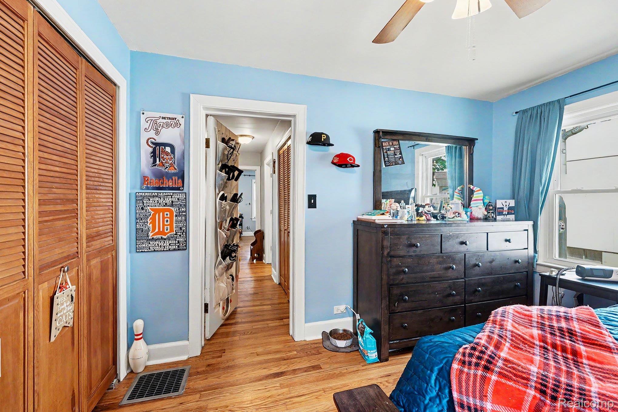 8215 Clinton River Road Sterling Heights, MI 48314 - Photo 15 of 28 Hardwood flooring paired with light blue walls