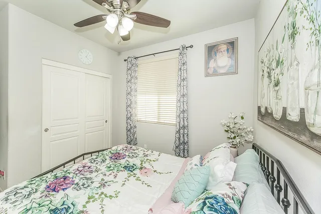 a bedroom with a bed and a chandelier