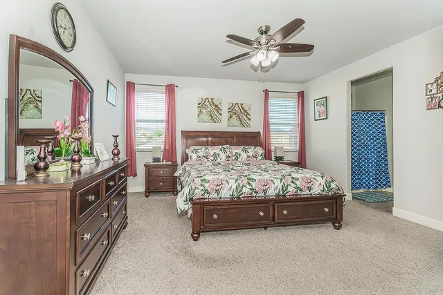 a bed sitting in a bedroom next to a window