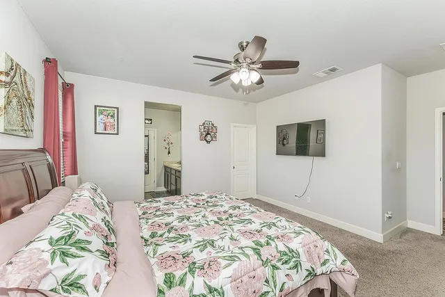 a bedroom with a large bed and a window