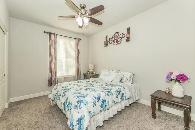 a bedroom with a bed and a table