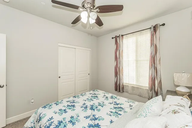 a bedroom with a bed and a window