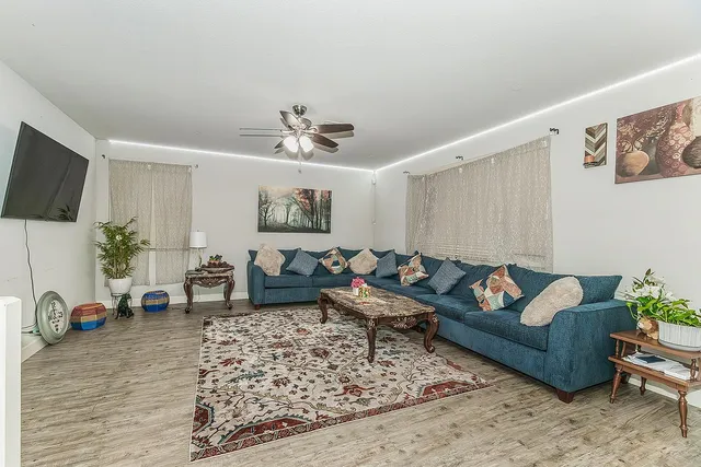 a living room with furniture and a flat screen tv