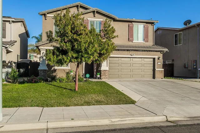 a front view of a house with a yard
