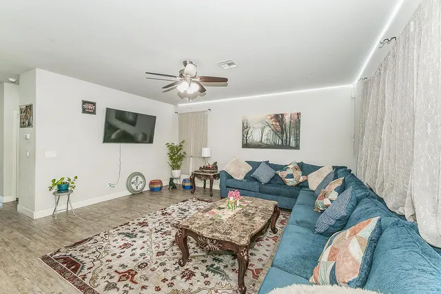 a living room with furniture and a flat screen tv