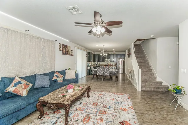 a living room with furniture and wooden floor