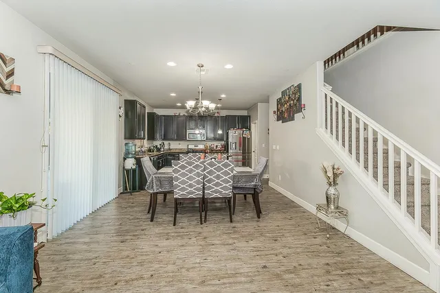 a dining room with furniture entryway and wooden floor