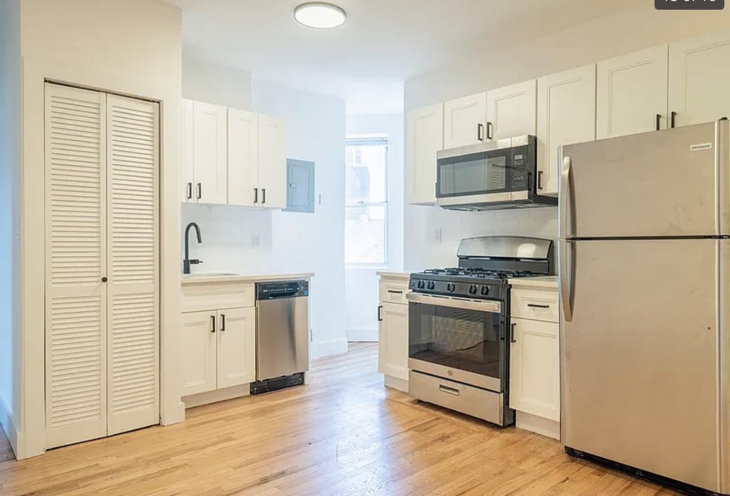 a kitchen with stainless steel appliances a refrigerator stove and microwave