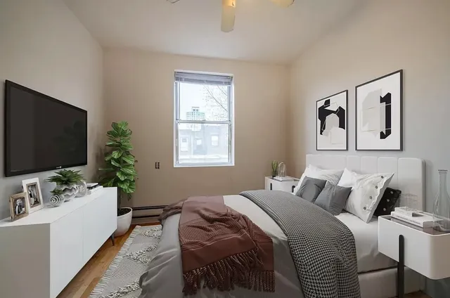 a bedroom with a bed and a flat screen tv