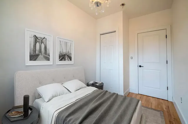 a bedroom with a bed and a painting on the wall