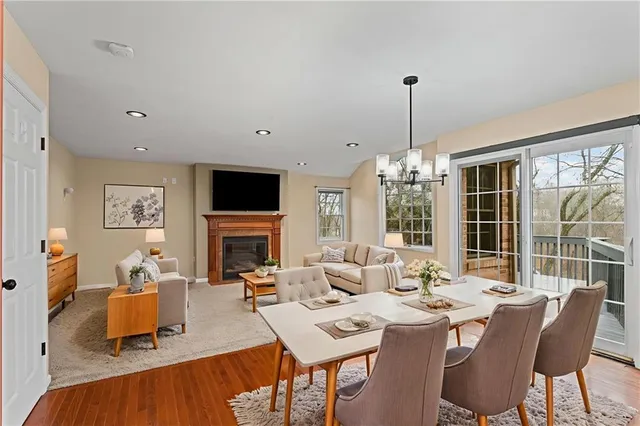 a living room with furniture a fireplace and a chandelier