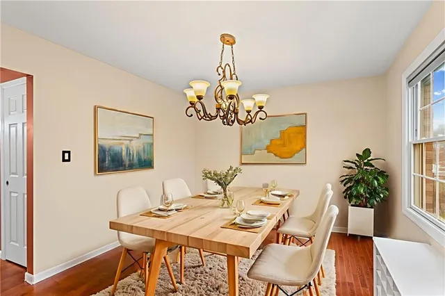a view of a dining room with furniture wooden floor and a chandelier