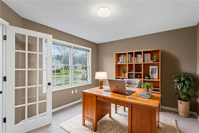 a living room with furniture a window and a potted plant