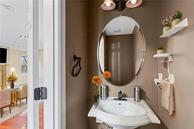 a bathroom with a sink mirror and toilet