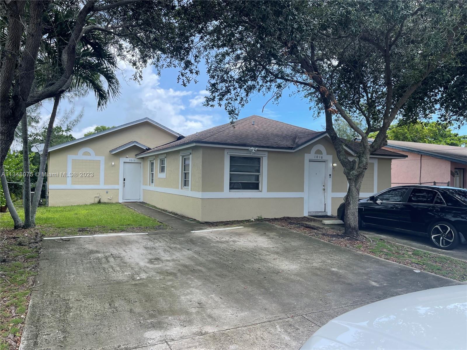 1016 Southwest 8th Street Hallandale Beach, FL 33009 - Photo 1 of 18 a view of a house with a yard