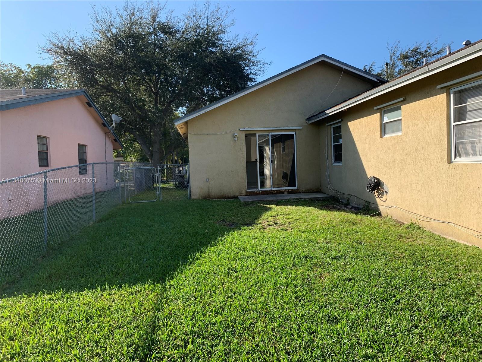 1016 Southwest 8th Street Hallandale Beach, FL 33009 - Photo 11 of 18 a backyard of a house with lots of green space