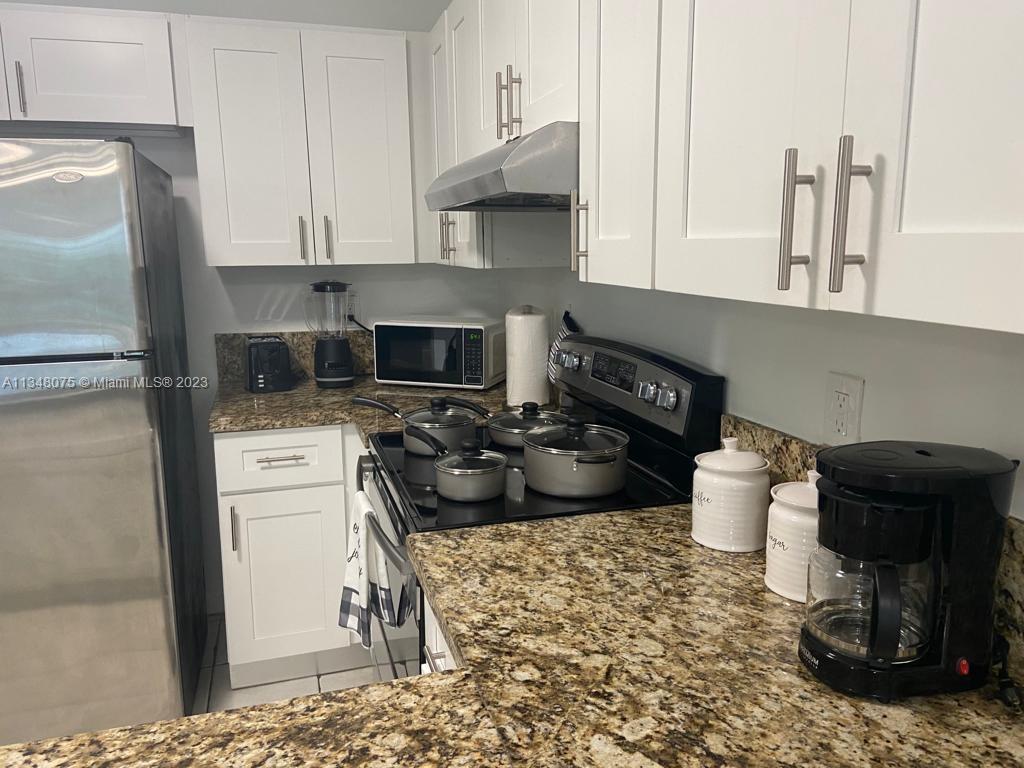 1016 Southwest 8th Street Hallandale Beach, FL 33009 - Photo 17 of 18 a kitchen with a sink and cabinets
