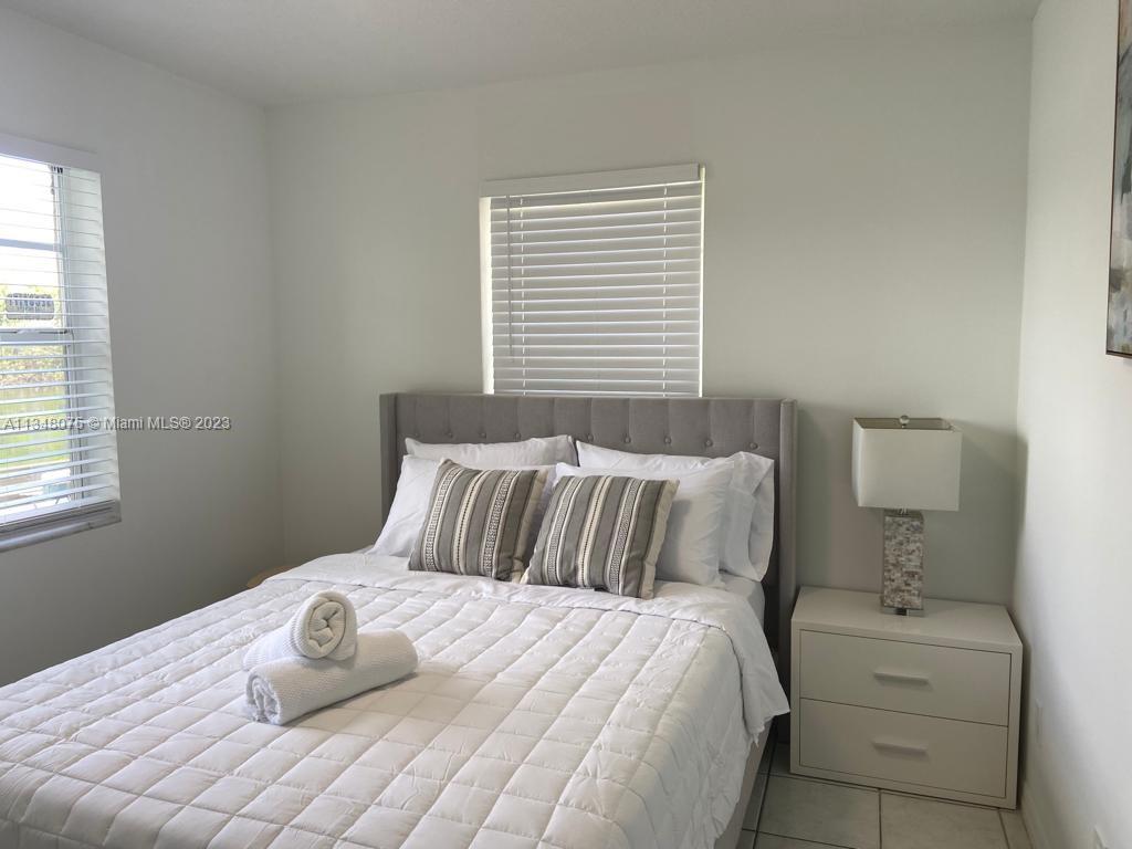 1016 Southwest 8th Street Hallandale Beach, FL 33009 - Photo 4 of 18 a bedroom with a bed and window