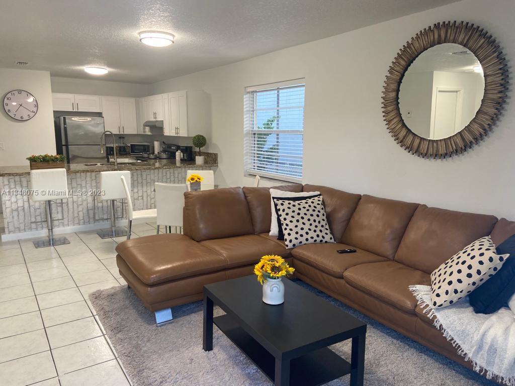 1016 Southwest 8th Street Hallandale Beach, FL 33009 - Photo 5 of 18 a living room with furniture and a mirror