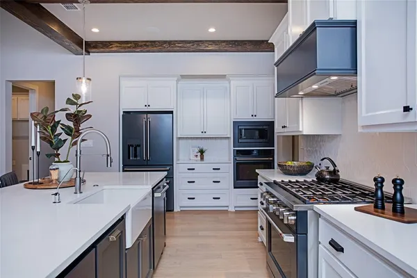 a kitchen with cabinets and appliances