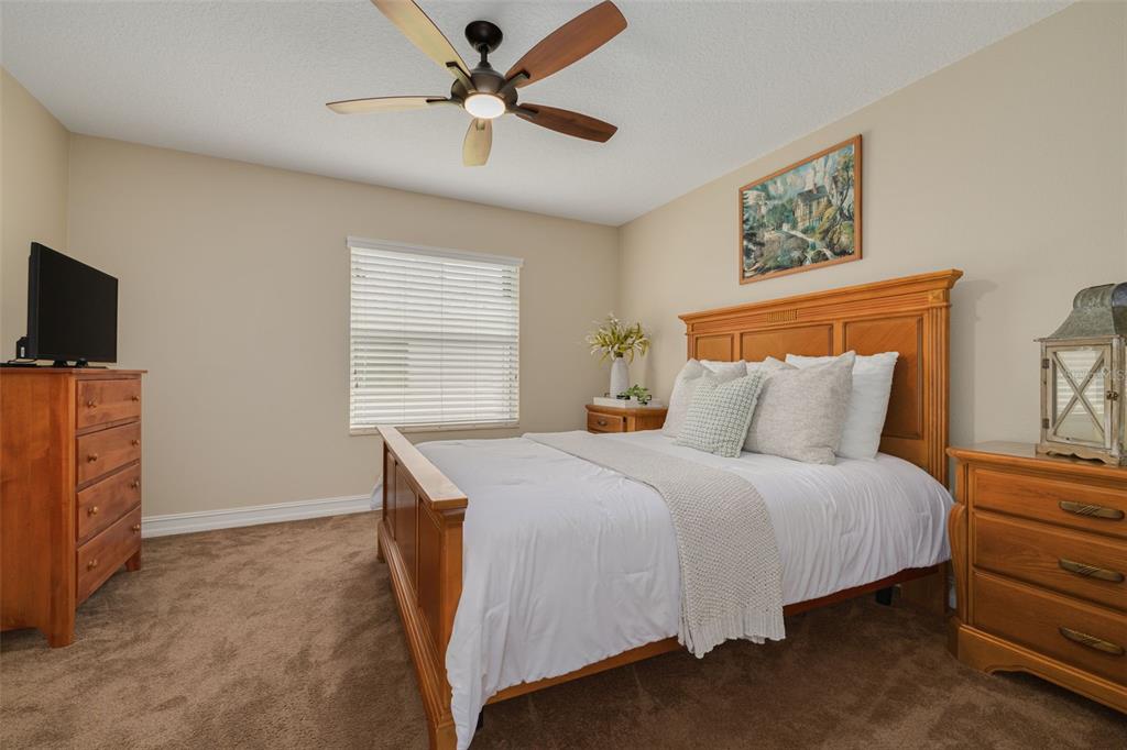 1701 Westerham Loop Trinity, FL 34655 - Photo 13 of 40 a bedroom with a bed and a flat screen tv