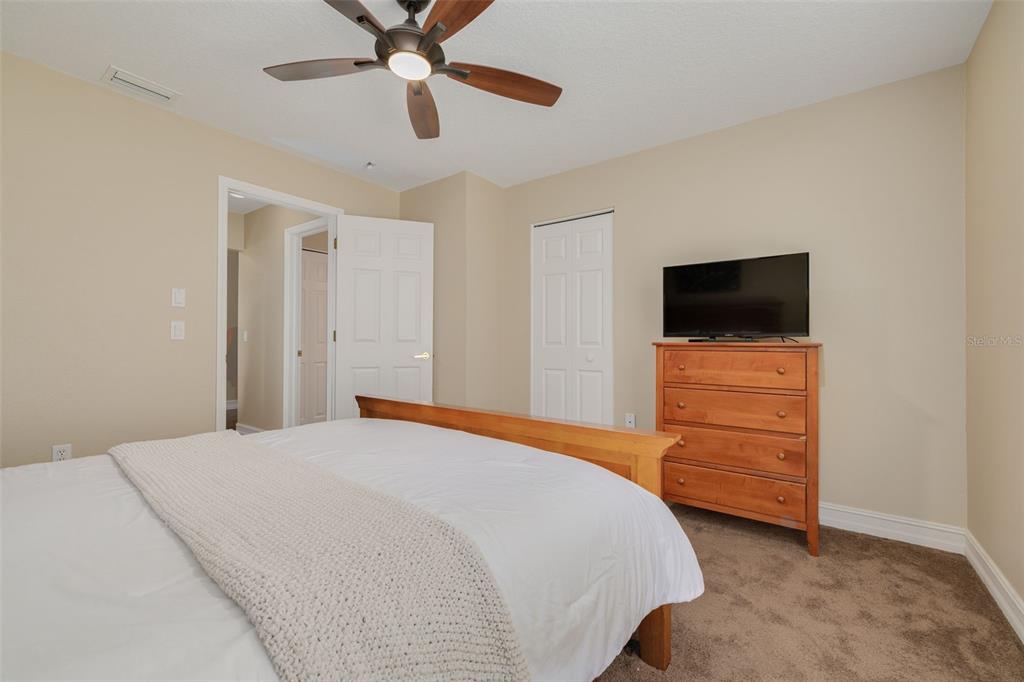 1701 Westerham Loop Trinity, FL 34655 - Photo 14 of 40 a bedroom with a bed and a flat screen tv