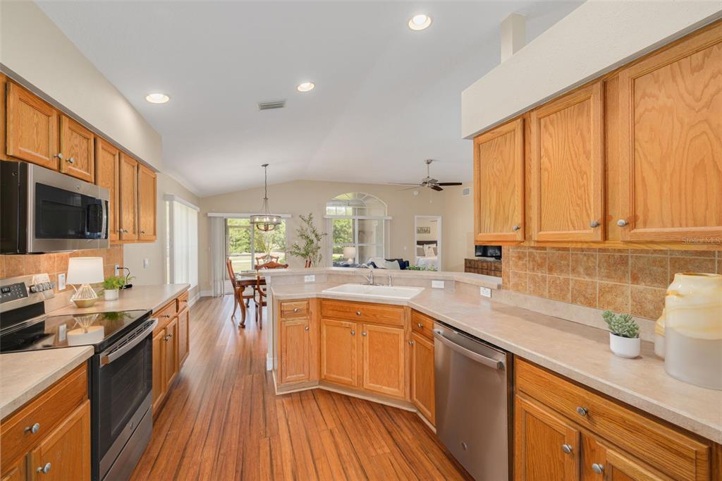 1701 Westerham Loop Trinity, FL 34655 - Photo 16 of 40 a kitchen with a sink wooden floor and counter top space