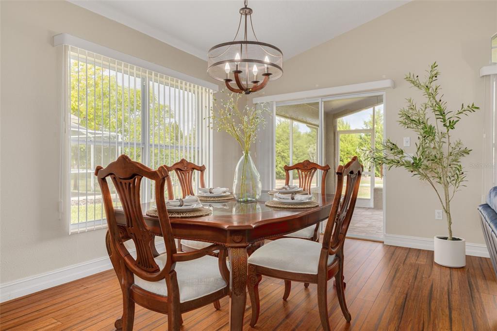 1701 Westerham Loop Trinity, FL 34655 - Photo 17 of 40 a dining room with furniture a chandelier and wooden floor