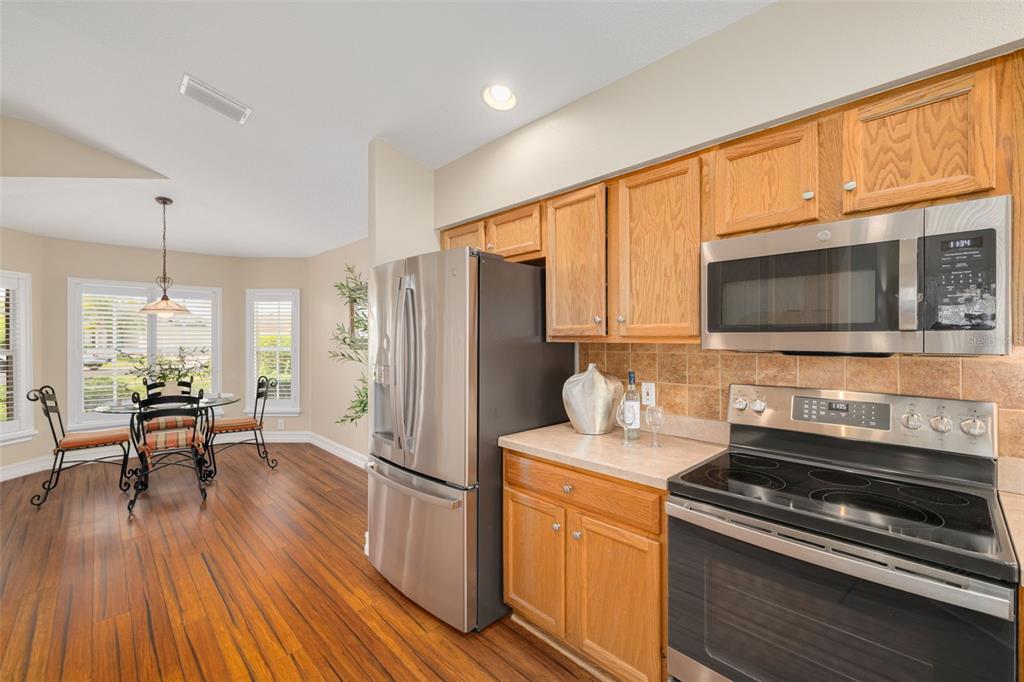 1701 Westerham Loop Trinity, FL 34655 - Photo 18 of 40 a kitchen with stainless steel appliances a stove a refrigerator and a microwave