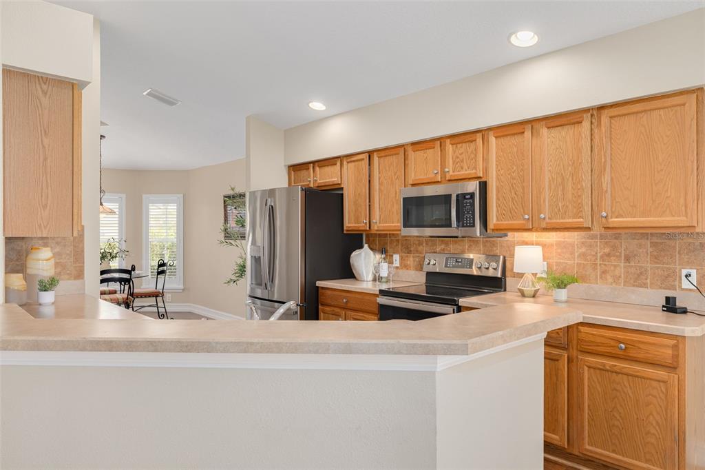 1701 Westerham Loop Trinity, FL 34655 - Photo 21 of 40 a kitchen with stainless steel appliances a stove a sink a microwave and refrigerator