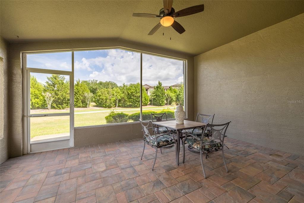 1701 Westerham Loop Trinity, FL 34655 - Photo 26 of 40 a view of a dining table and chairs in porch