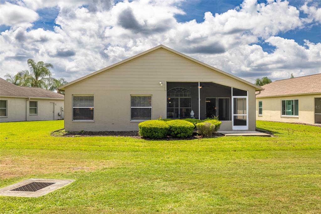 1701 Westerham Loop Trinity, FL 34655 - Photo 31 of 40 a view of a house with a patio and a yard