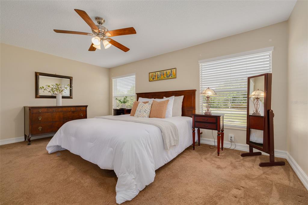 1701 Westerham Loop Trinity, FL 34655 - Photo 7 of 40 a bedroom with a bed and a chandelier