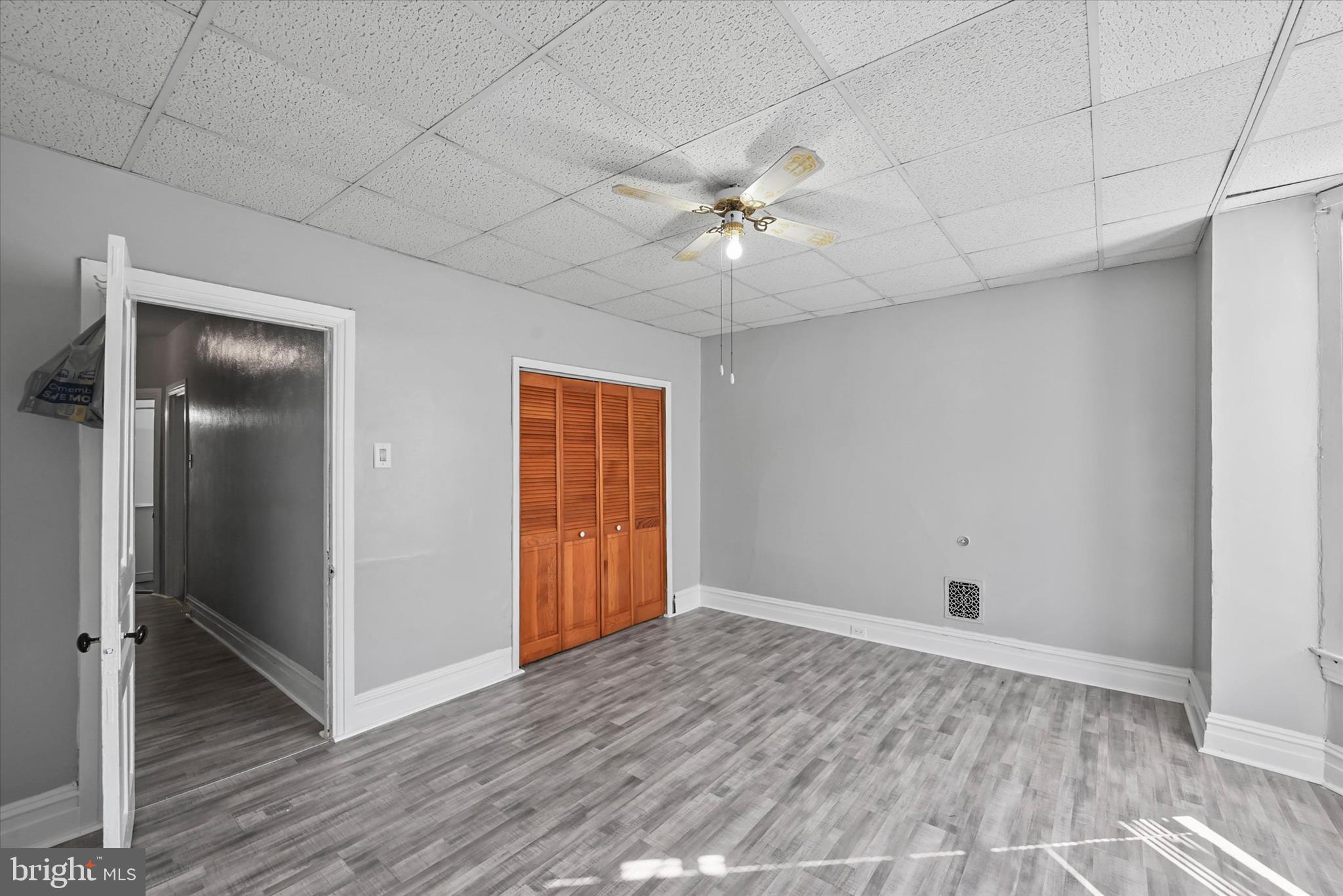 707 York Street York, PA 17403 - Photo 17 of 32 an empty room with wooden floor and ceiling fan