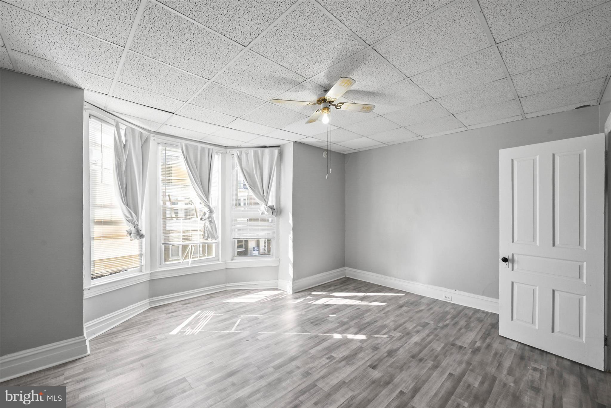 707 York Street York, PA 17403 - Photo 18 of 32 an empty room with wooden floor and windows