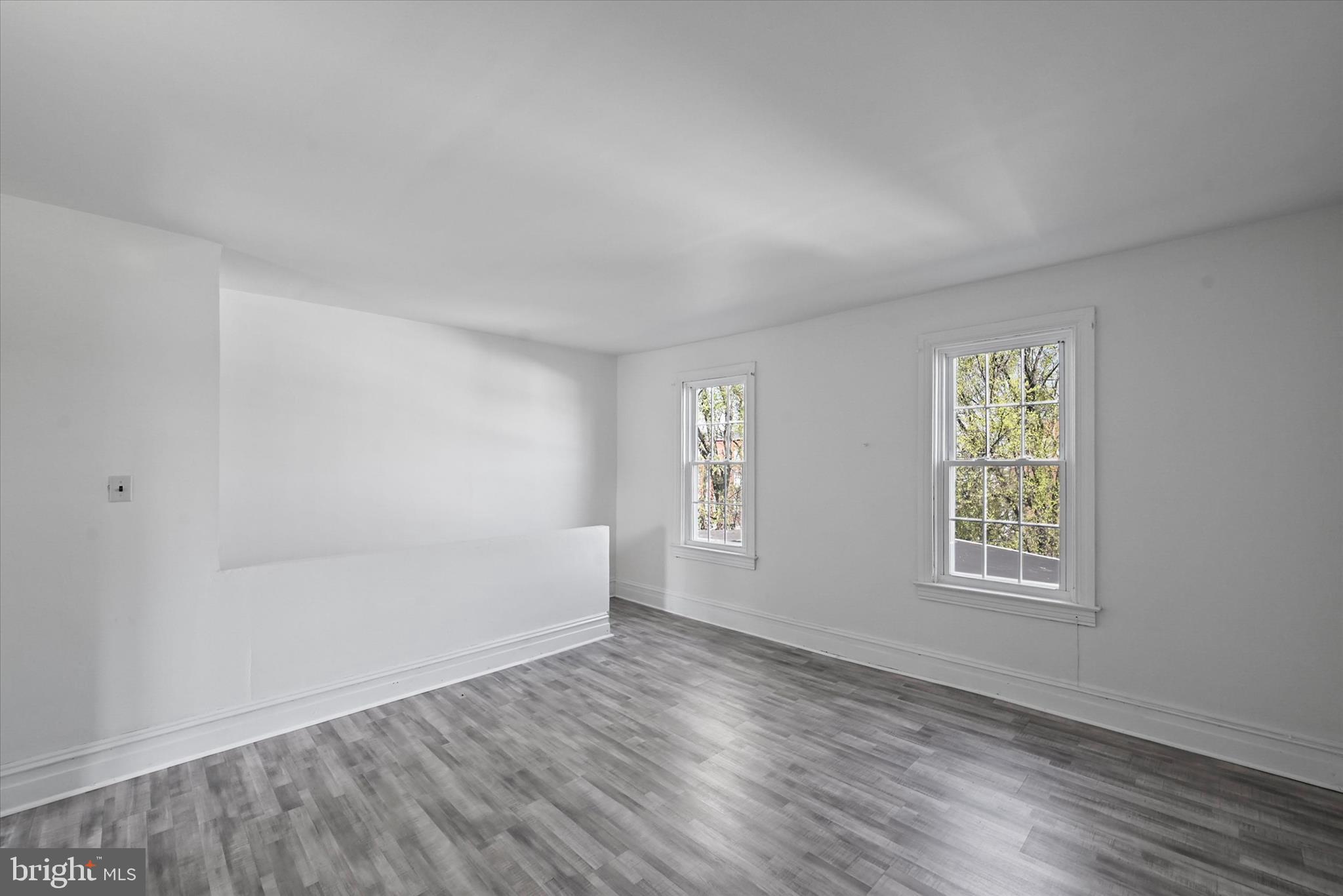 707 York Street York, PA 17403 - Photo 21 of 32 an empty room with wooden floor and windows