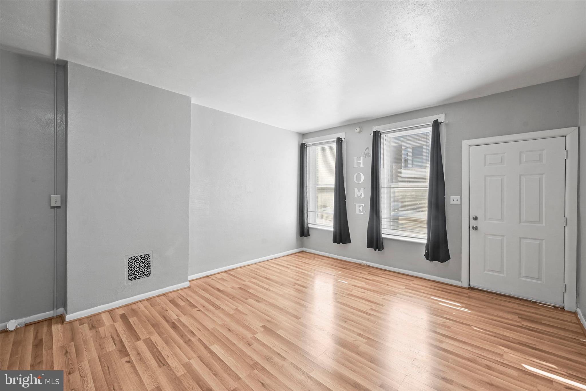 707 York Street York, PA 17403 - Photo 5 of 32 an empty room with wooden floor and windows