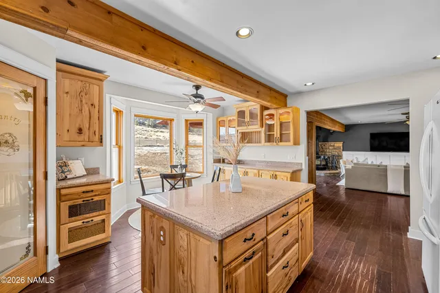 a kitchen with a stove a refrigerator and wooden floor
