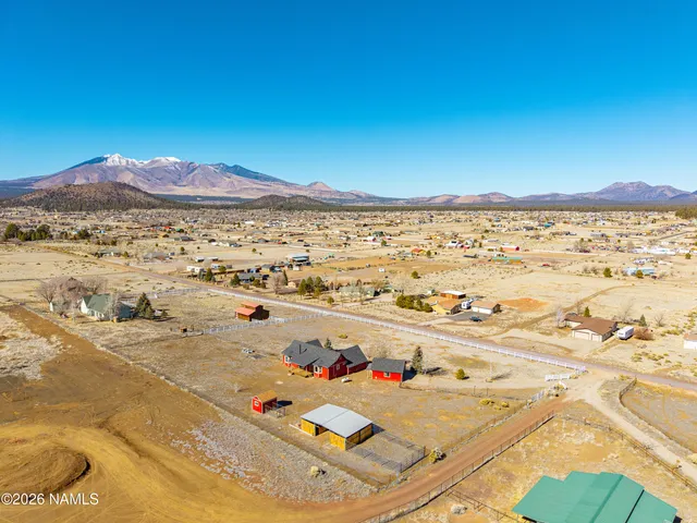 a view of a houses with cars parked in front of the house