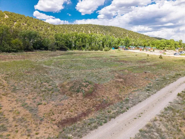 a view of a field with an ocean