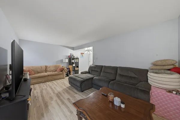 a living room with furniture wooden floor and a flat screen tv