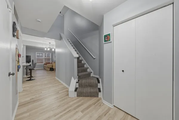 a view of entryway and hall with wooden floor
