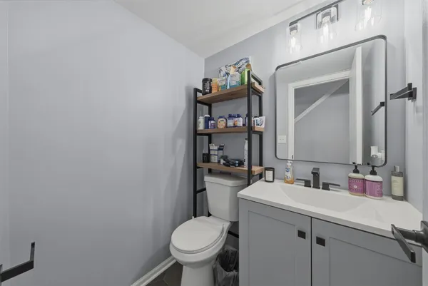 a bathroom with a sink toilet and mirror