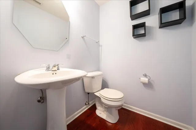 a bathroom with a sink toilet and a mirror