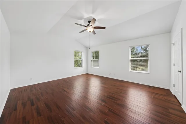 wooden floor in an empty room with a window