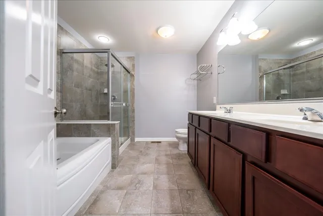 a bathroom with a tub sink shower and mirror