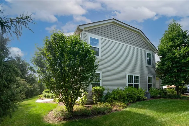 a yellow house with garden in front of it