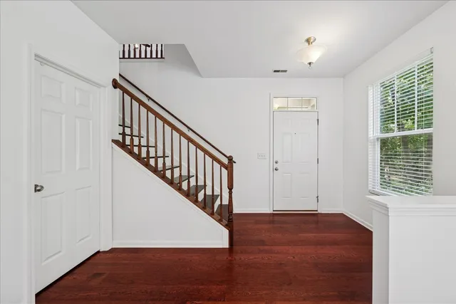 a view of entryway and hall with wooden floor